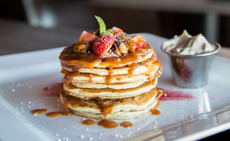 Pancakes with berries and syrup